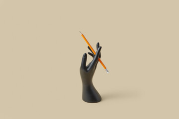 Black mannequin hand holding graphite pencil.