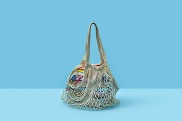 String bag with various books inside.