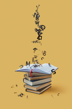 Black paper letters falling down on book stack.
