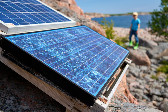 Solar panel, photovoltaic PV cell and young person in background
