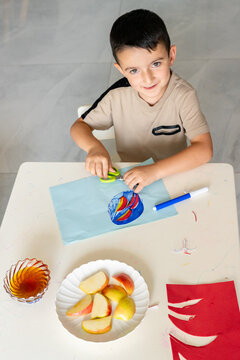 Healthy Harvest. Boy Creating Apple and Honey Art.