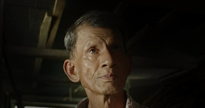 An Asian man who is an elderly worker live in a poor dark house. Used in film concepts, humanity, documentaries and others.