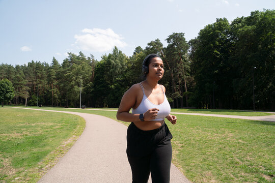 Plus Size Woman Running In The City Park