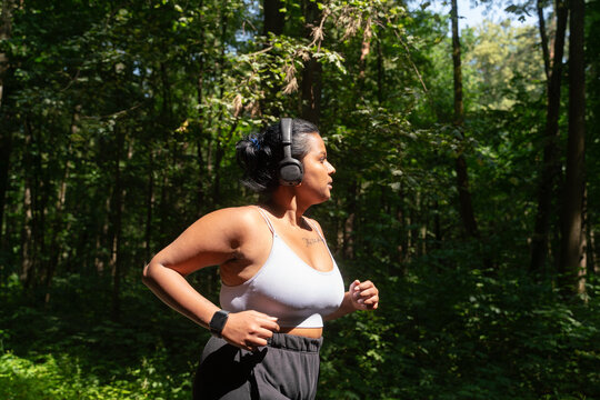 Curvy Woman Running In The Forest