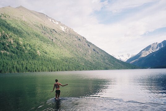 Swimming in cold mountain lake 