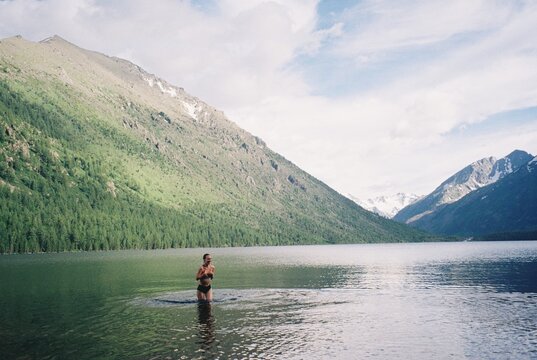 Swimming in cold mountain lake 