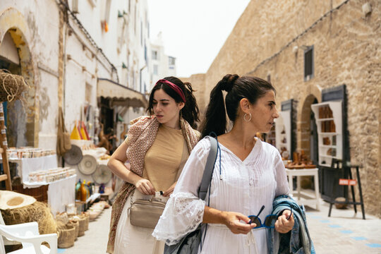 Women visiting an Arab city, looking at the street stalls.
