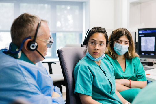 Doctors in computer room discussing data