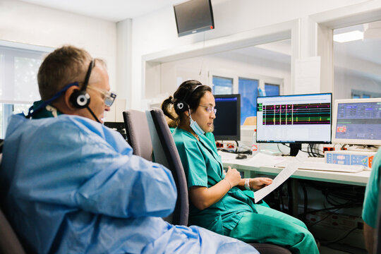 Doctors in computer room discussing data