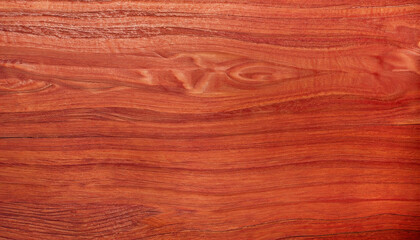 Fototapeta premium the background of red polished wood texture with a beautiful pattern; close-up