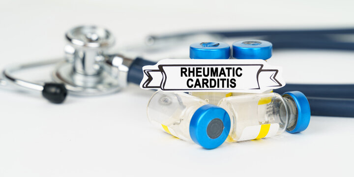 On the table there is a stethoscope, injections and a sign with the inscription - Rheumatic carditis