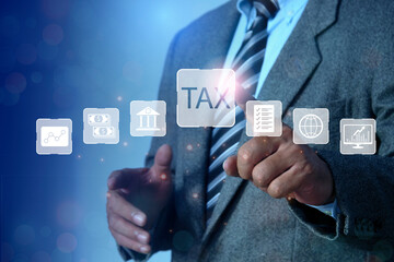 income tax concept. Businessman pointing to tax icon. pay online income tax. futuristic virtual...