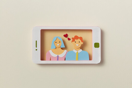 Handmade paper smartphone with video call of couple in love