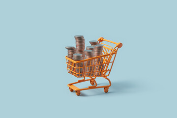 Miniature shopping cart with stacks of coins.