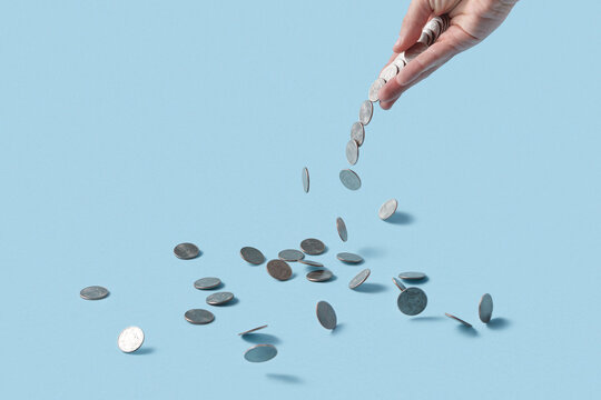 Woman's hand scattering cent coins.