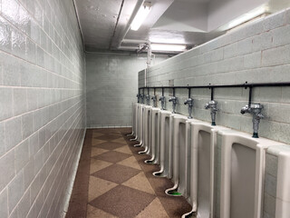 Empty toilet with ceramic urinals