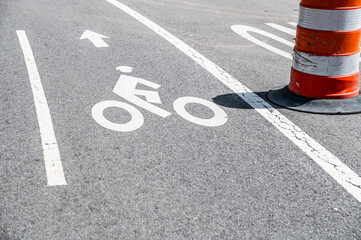Asphalt road parking lot with rider mark and traffic barrel