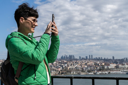 Tourist taking photos with mobile phone.