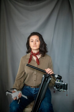 Portrait of an attractive girl with a camera and a quadcopter