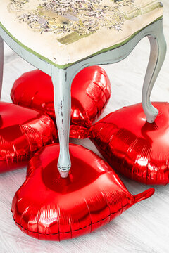 vintage classic chair stands on balloons in the shape of a heart