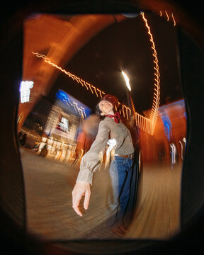Happy attractive girl in motion and lights of the night city