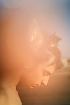 Side view portrait of young man with blur light effect