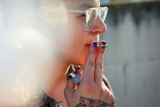 Side portrait of Zoomer smoking with light effect