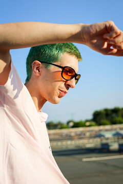 Non-binary alternative person with colorful hair dancing