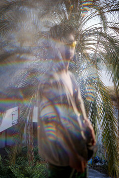 Double exposure picture of man and tropical palm tree