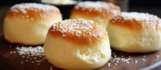 A close-up view of a plate filled with homemade bread rolls, showcasing their golden-brown crust and fluffy interior. These delicious baked goods are perfect for breakfast or a snack.
