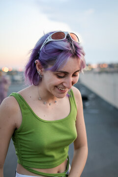 Candid portrait of purple hair zoomer woman 
 laughing