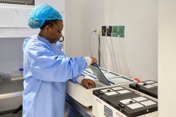 Embryologist placing an egg in an incubator