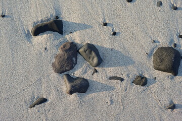 rocks and sand at beach in afternoon