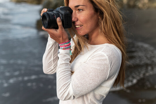 Digital nomad with camera at tropical beach