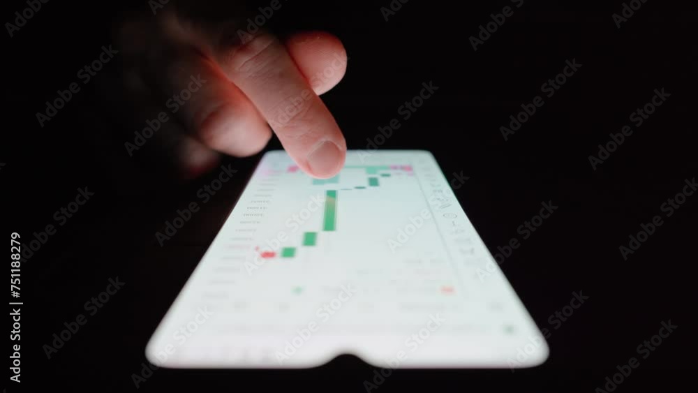 Poster man browsing candlestick chart on a smartphone. close up