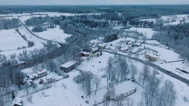 Snowy Abava river near Renda village (Kuldiga parish, Latvia) during winter, serene landscape, aerial view, moving forward