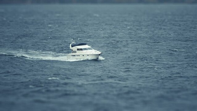 A small motor boat in the stormy open sea.