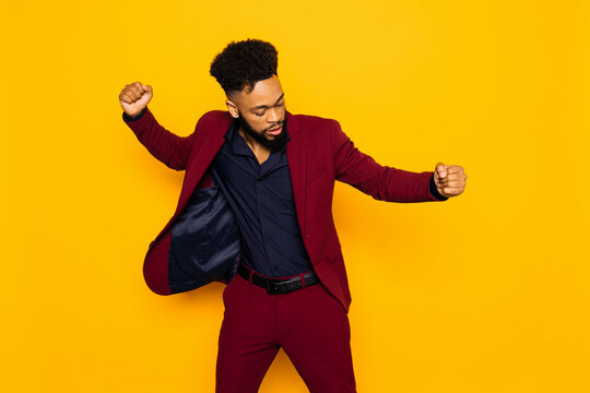 Cheerful elegant black man dancing in studio