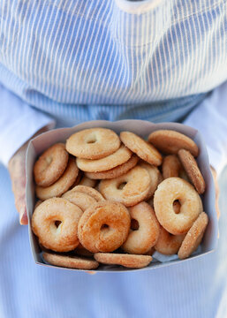Hands holding a box full of cookies