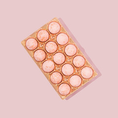 Pattern composition made of pastel color eggs on the shiny golden carton. Easter minimal concept idea. Flat lay, Top view.