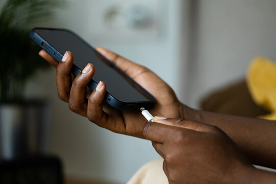 Woman Putting Phone to Charge 