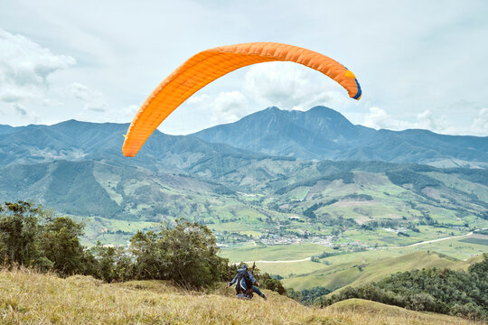 Man jumping in paragliding