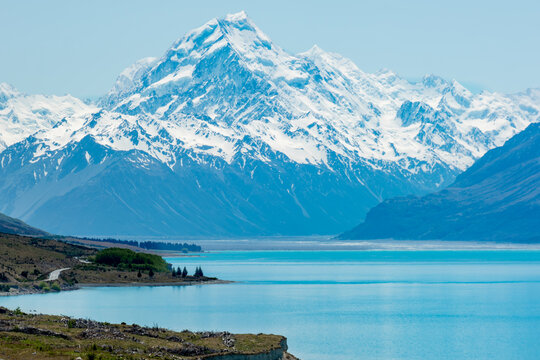 Closer view of a snow capped mountains and a turquoise glacial lake