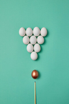 White and golden eggs stylized as snooker set.