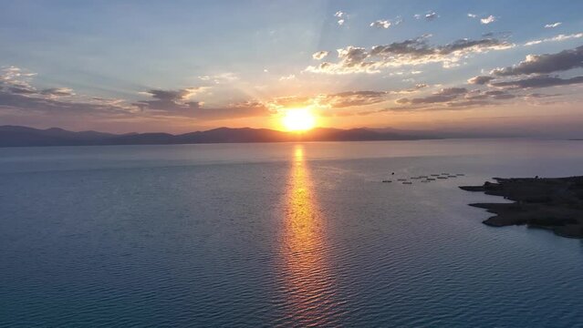 Scenic sunset or sunrise over Sevan lake popular holiday destination in Armenia, Caucasus, West Asia. Daytime of moving white, grey clouds over lake Sevan on background hills