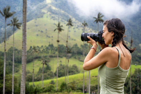 Woman taking pictures in the Cocora Valley