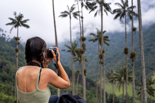 Woman taking pictures in the Cocora Valley