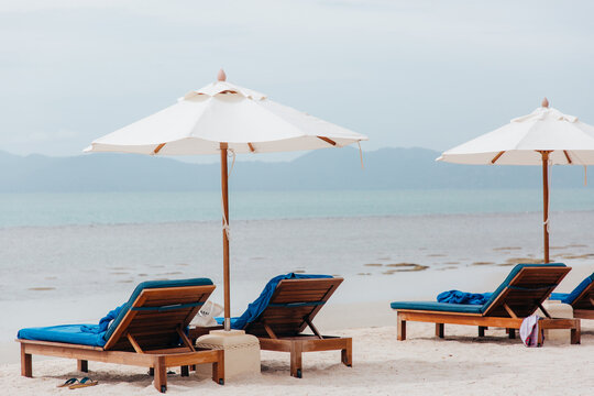 Sun loungers and parasols on a tropical beach