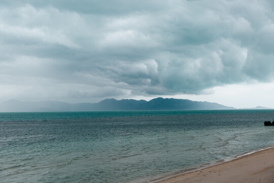 a tropical beach with bad weather approaching