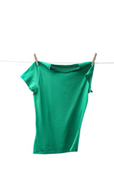 One green t-shirt drying on washing line isolated on white